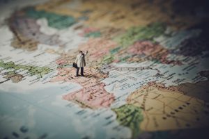 male figure standing on France on a map