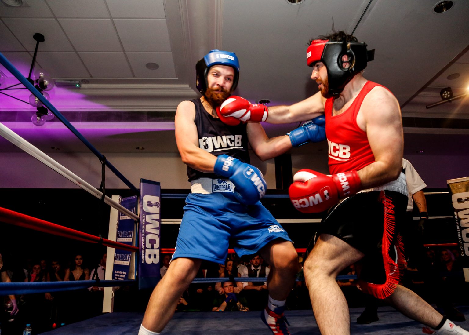 Youtuber Sir Vaping a lot inside a boxing ring with a fellow boxer receiving a blow to the face