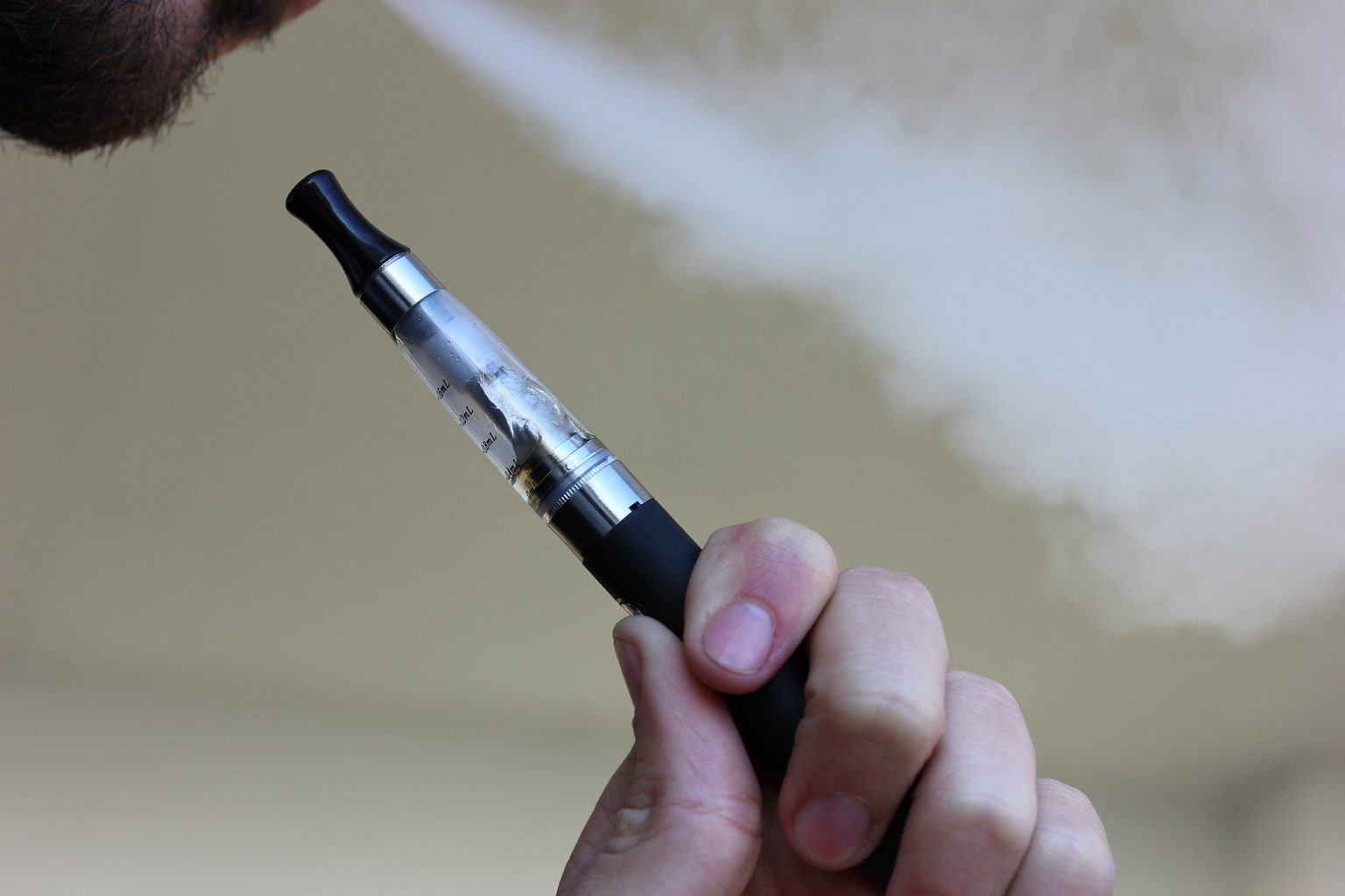 a man vaping on a vape pen