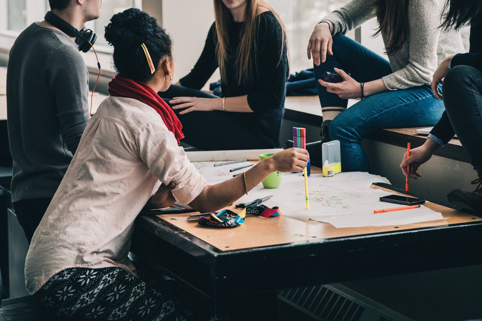 group of people sat around a table strategising