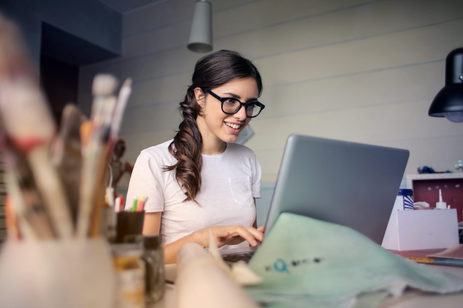 a woman sat working on a laptop