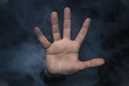 a hand breaking through a cloud vape clouds