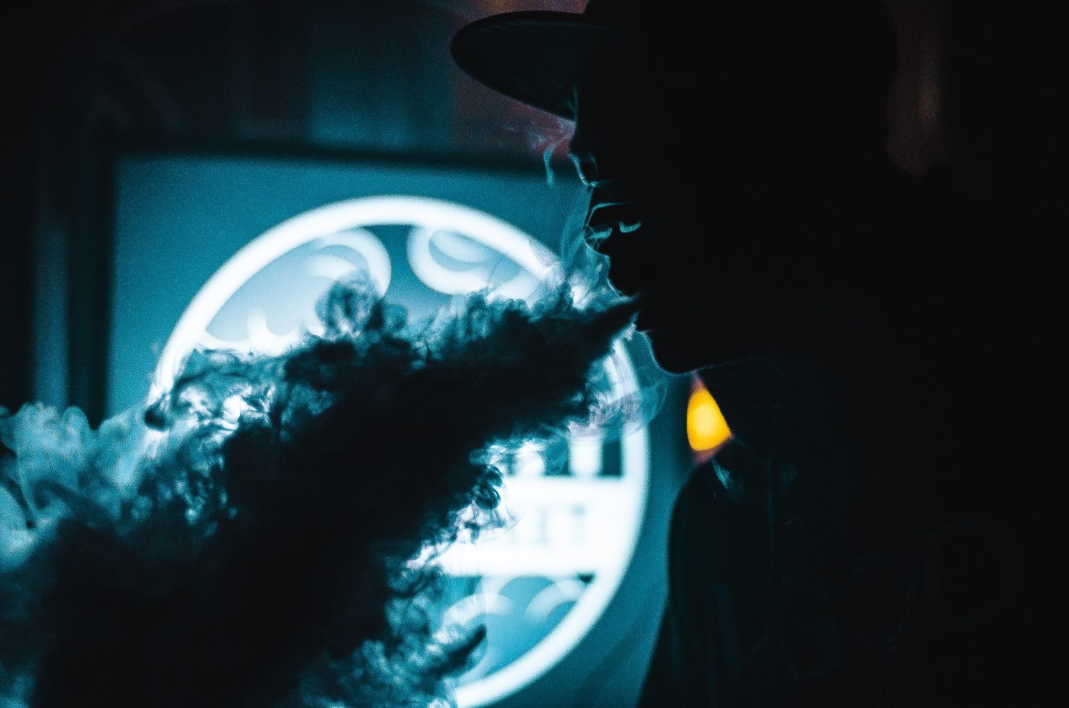 a man blowing clouds from vaping