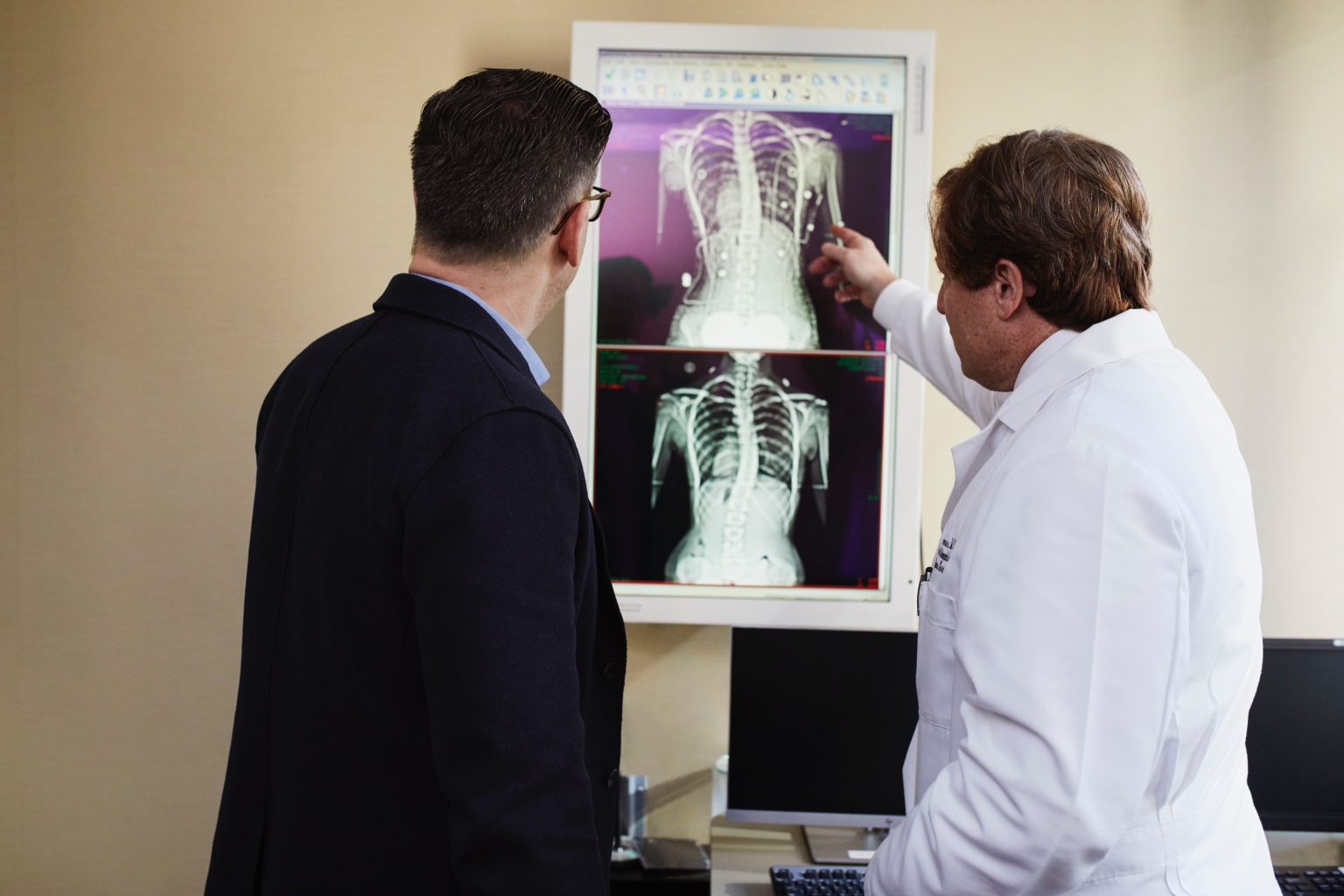 a doctor and a man examining an xray