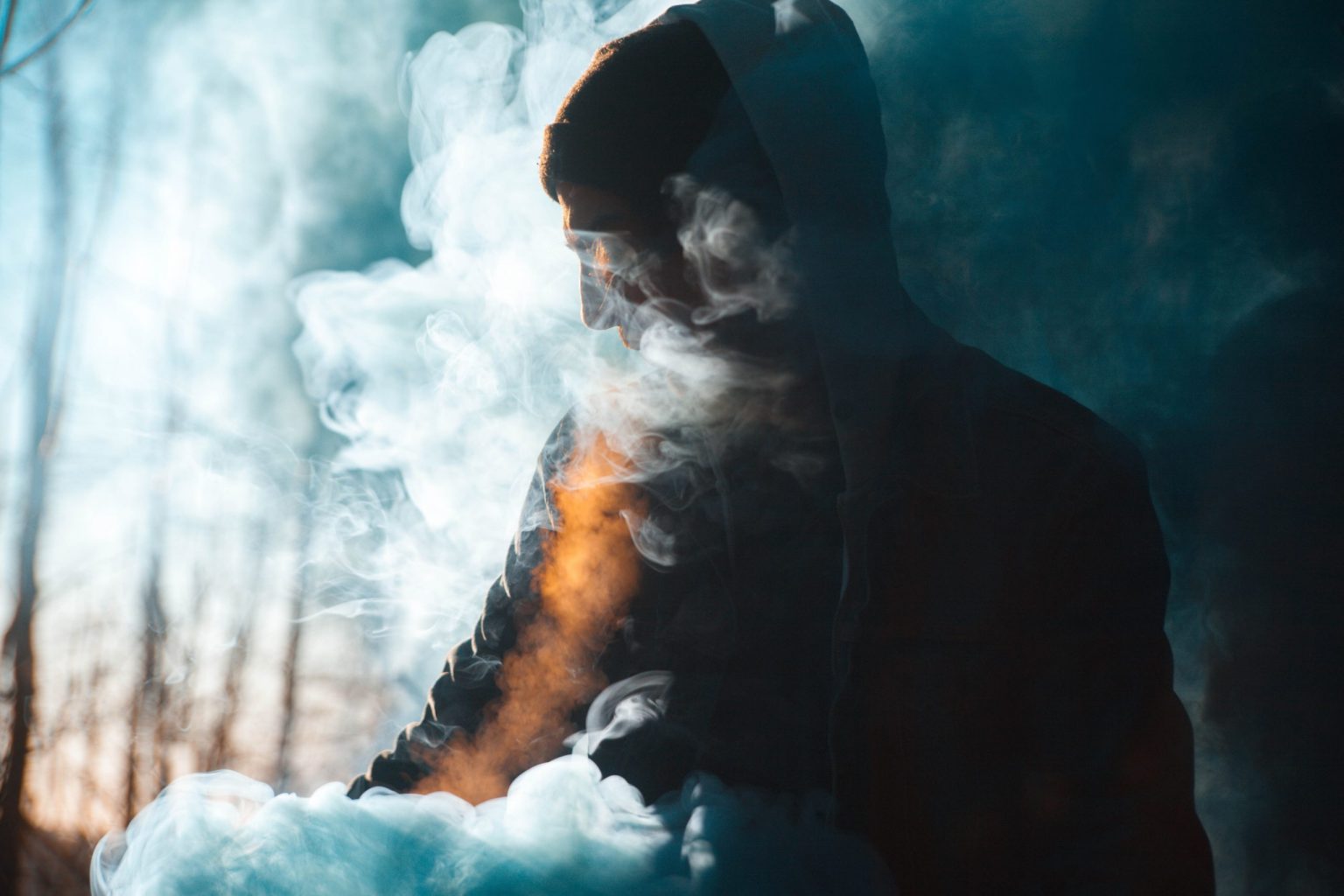 a man vaping and blowing big clouds