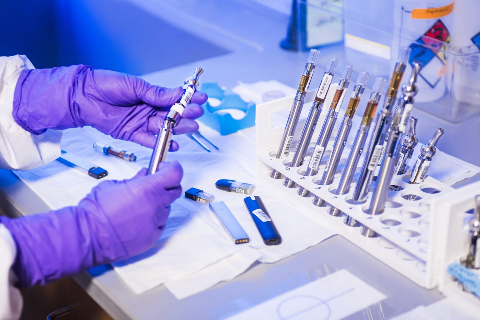 scientist inspecting vapes with eliquids