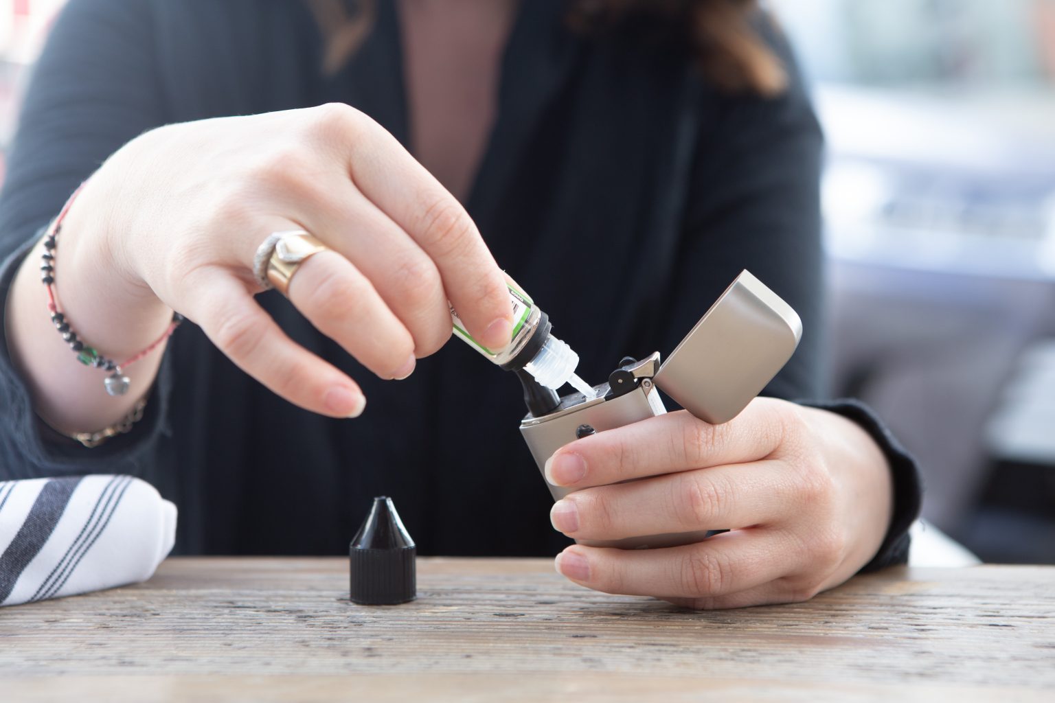 A pair of hands refilling a vape