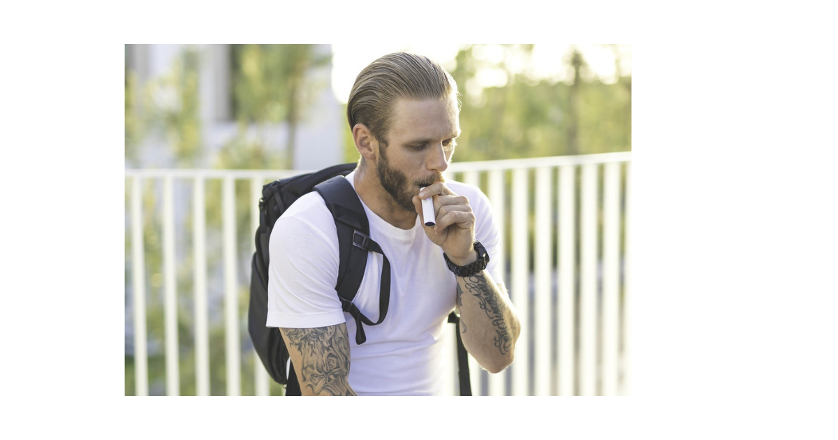 Man in white t-shirt vaping