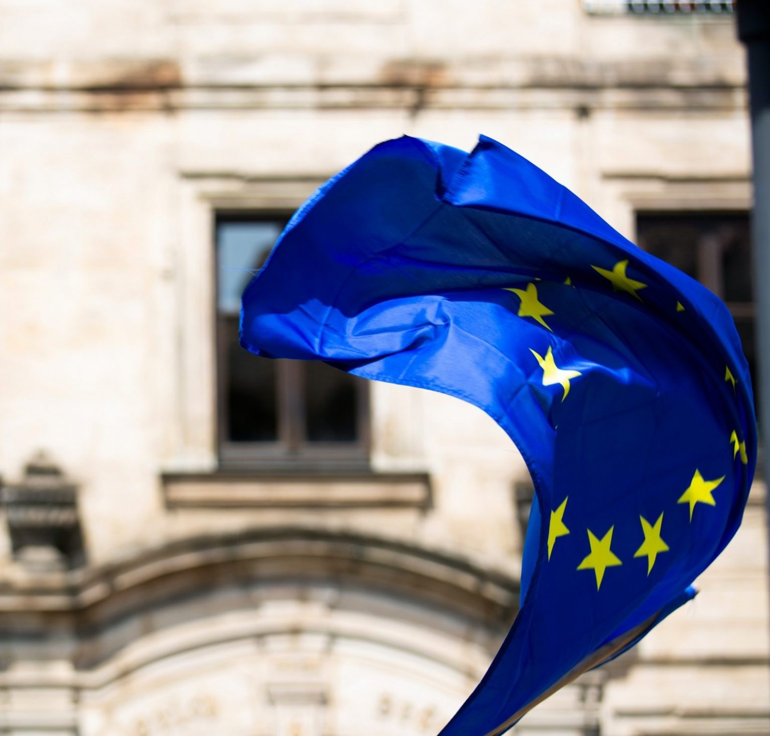 EU flag blowing in the wind outside European parliament