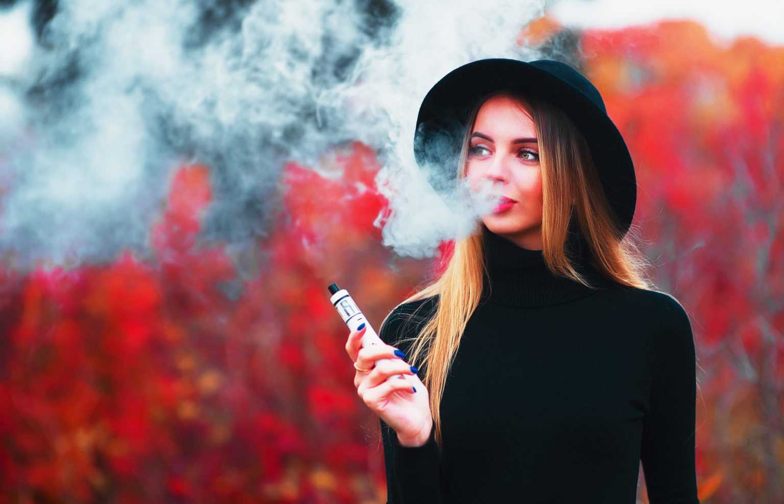 Woman in hat vaping