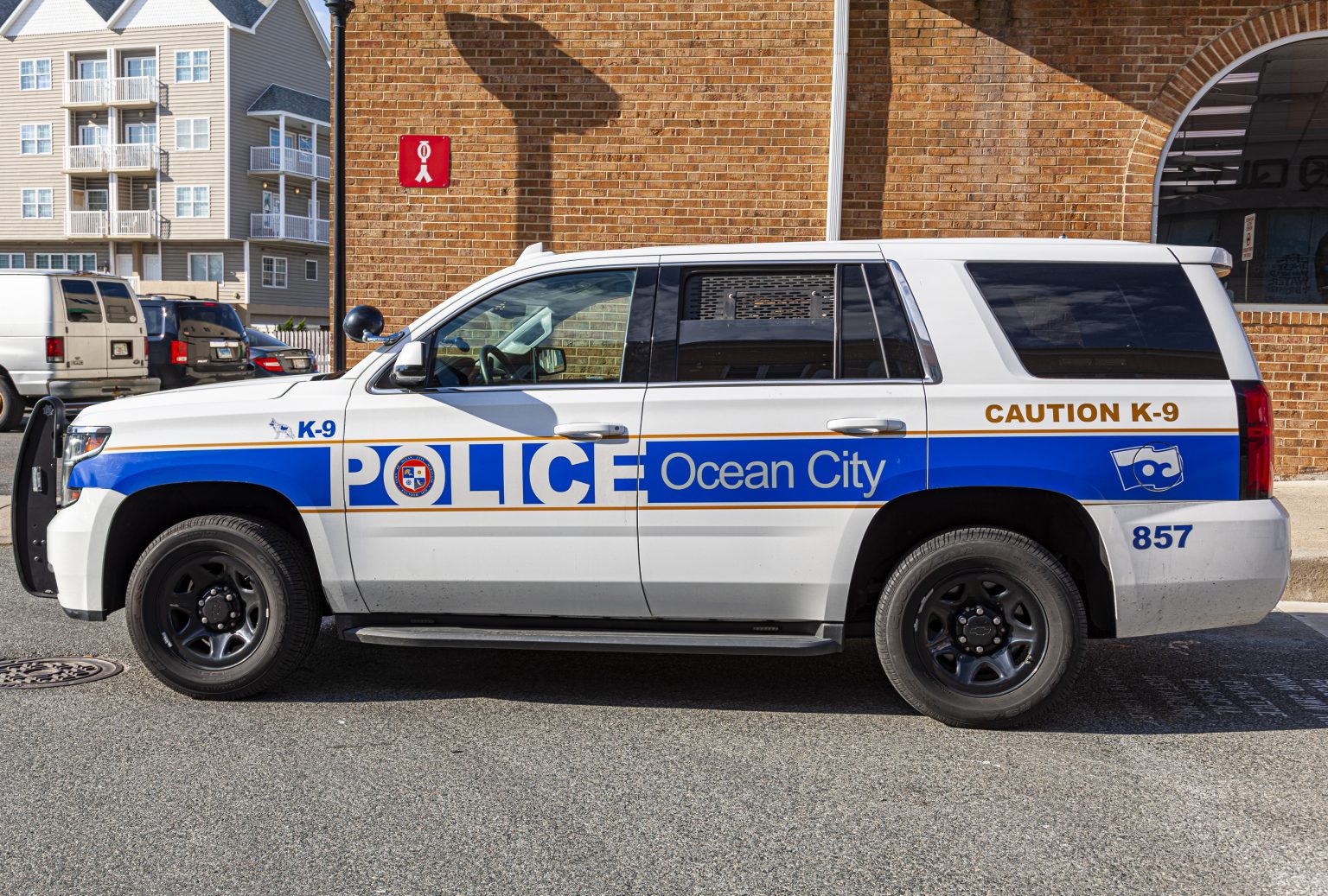 Ocean City, MD, USA 04-18-2021: A Ford Explorer Police vehicle belonging to Ocean City Police department is idling near the board walk. This is a K-9 unit with the trained dog inside the car.