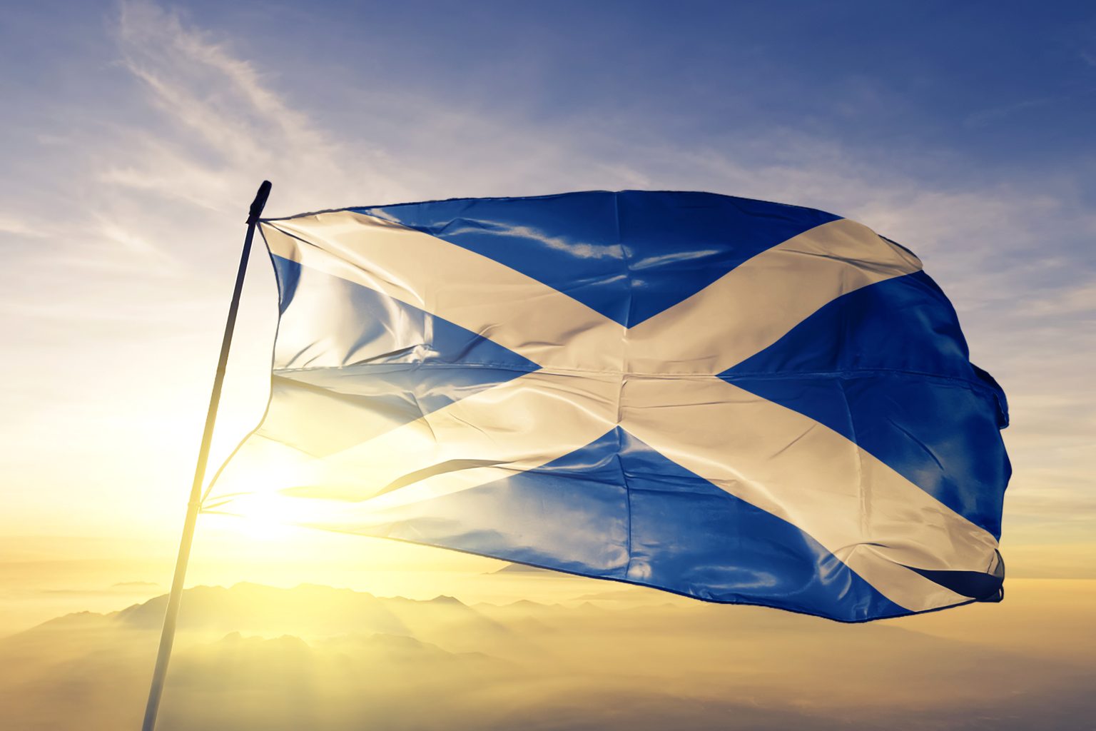 Scotland scottish flag textile cloth fabric waving as the sun sets