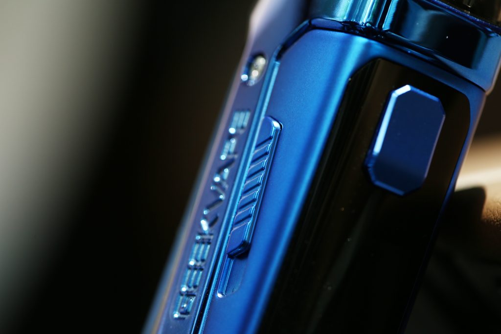 close up of the A-lock sliding locking switch on a blue geekvape aegis boost 2 (B60) vape device