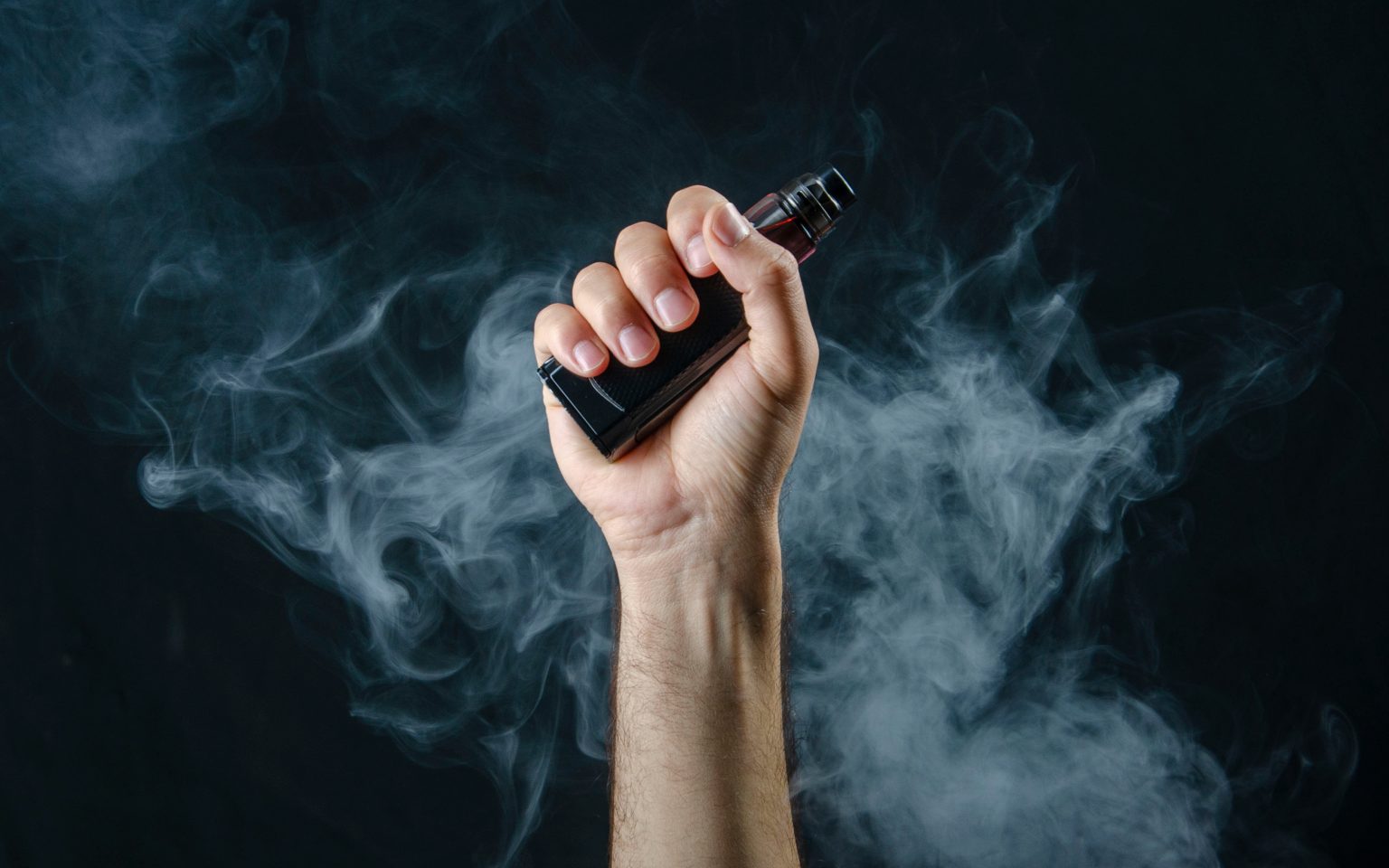 hand holding vape e-cigarette or electronic cigarette with white