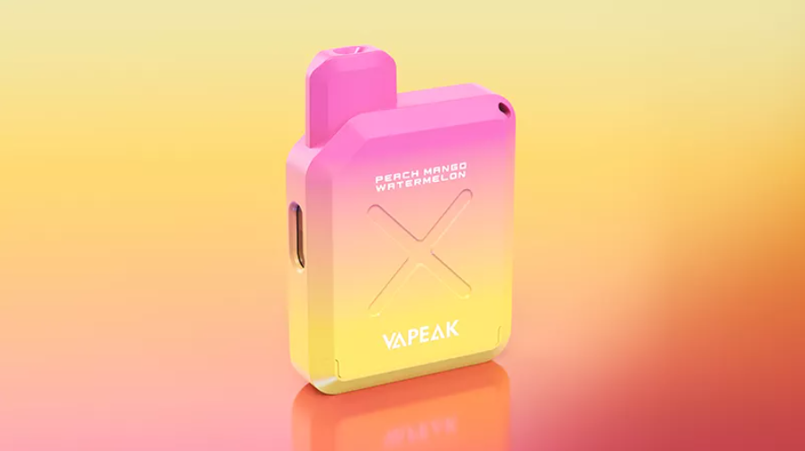 vapeak vision disposable vape sat on a yellow and pink background