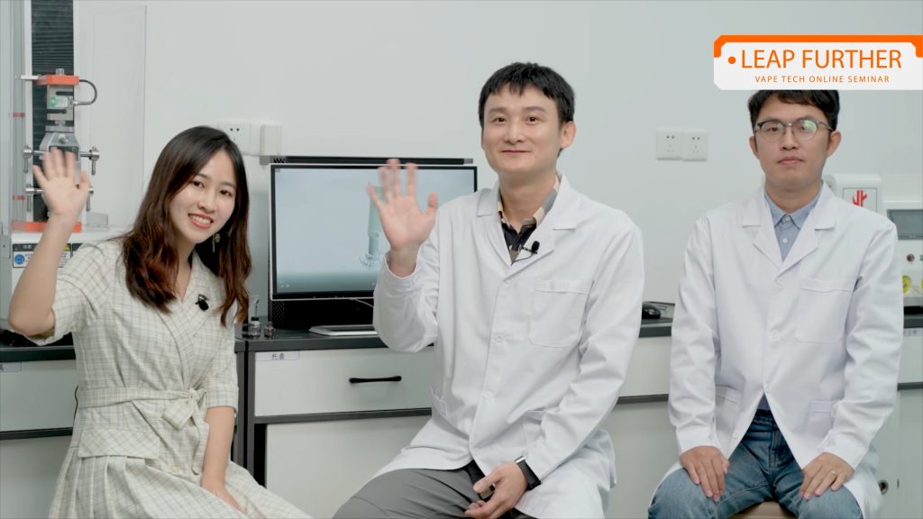 three happy geekvape lab technicians waving in a science laboratory