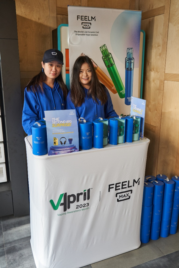 feelm team stood behind branded table at their VApril event 