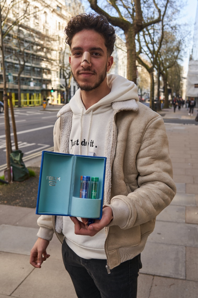 young man holding feelm max technology sample vapes