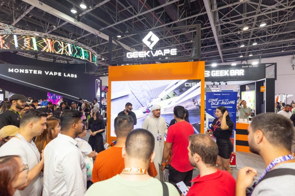 geekvape team entertaining a crowd of visitors at the world vape show dubai exhibition