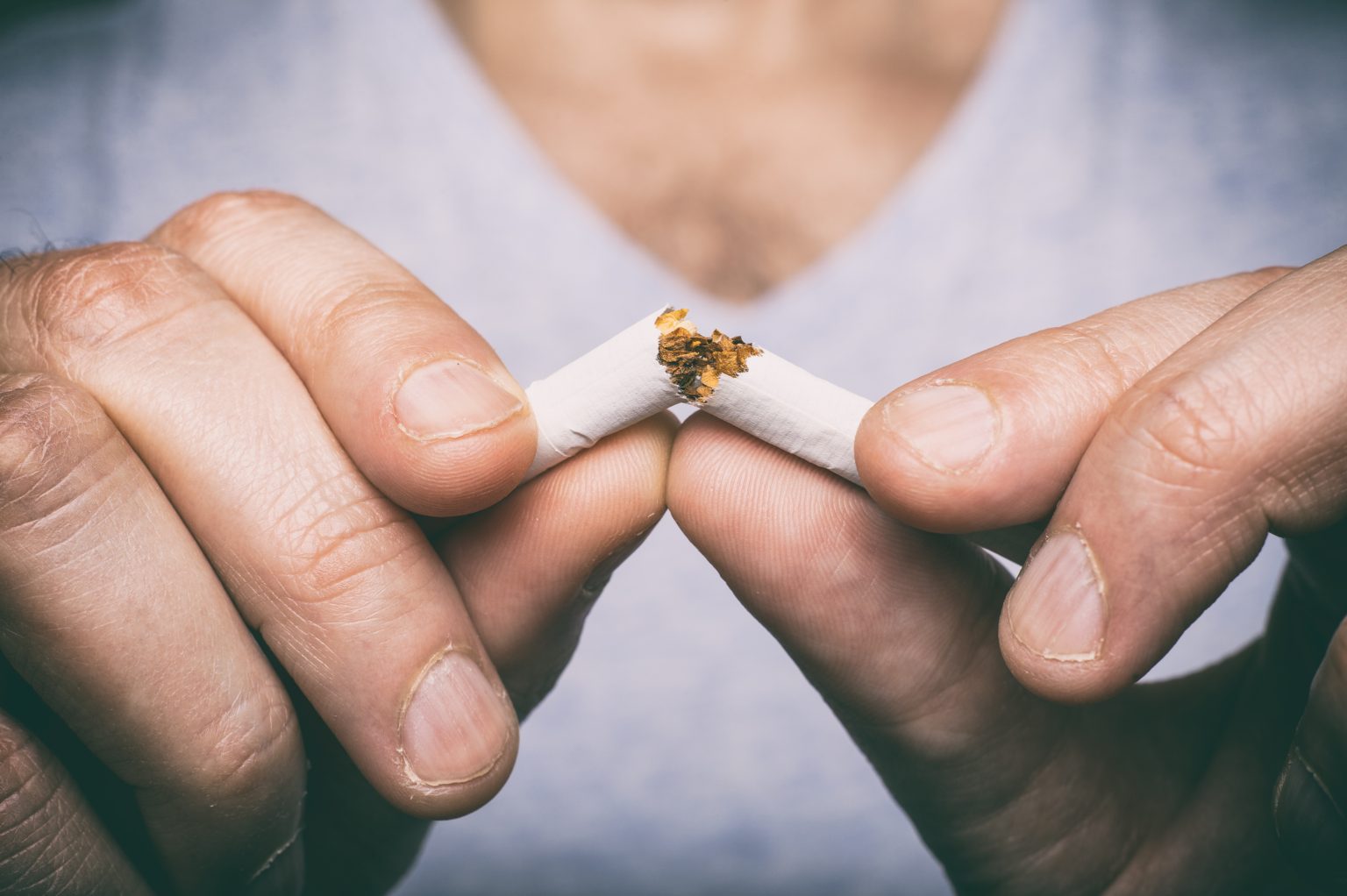 male hand crushing cigarette