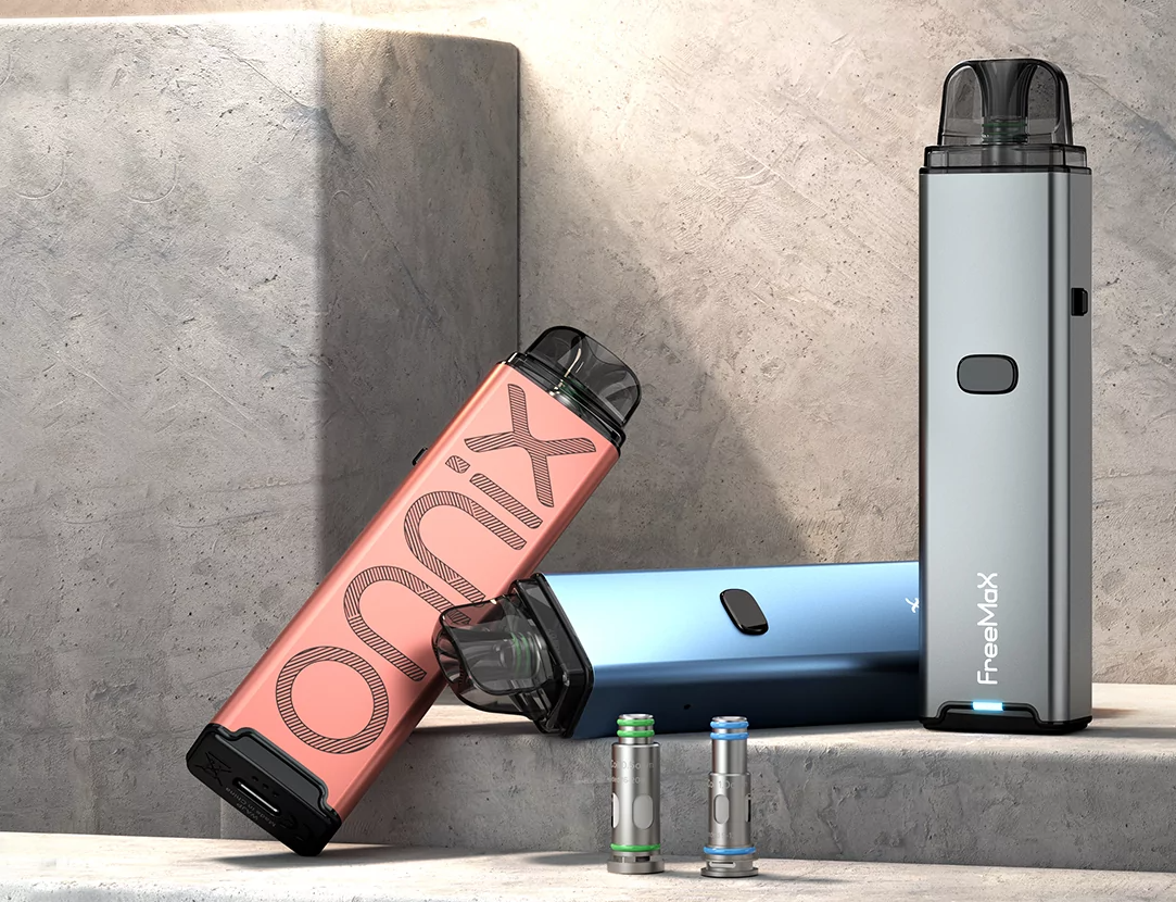 three freemax onnix vape pod systems devices sat on a stone stand