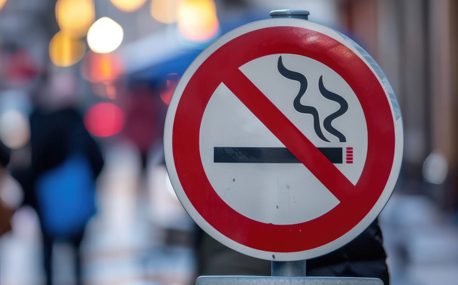 red and white no smoking sign in a public city centre