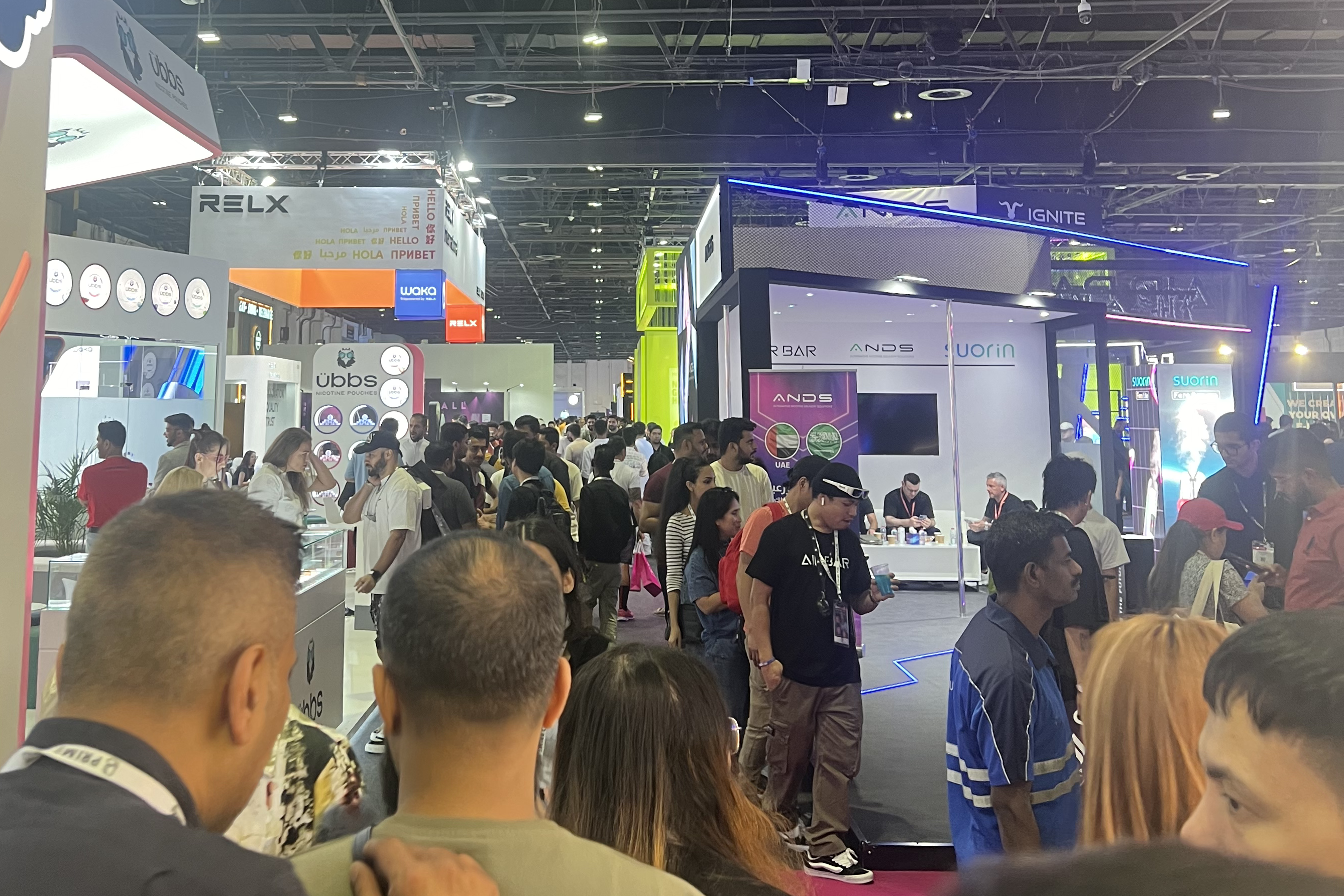 large numbers of visitors walking around a vaping trade show hall, talking with exhibitors and looking at vape products during the World Vape Show Dubai 2024