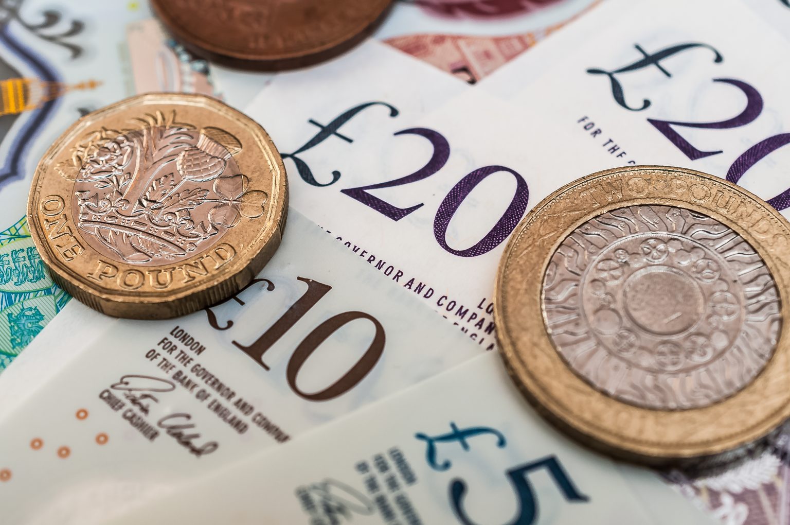 British pounds banknotes and pound coins