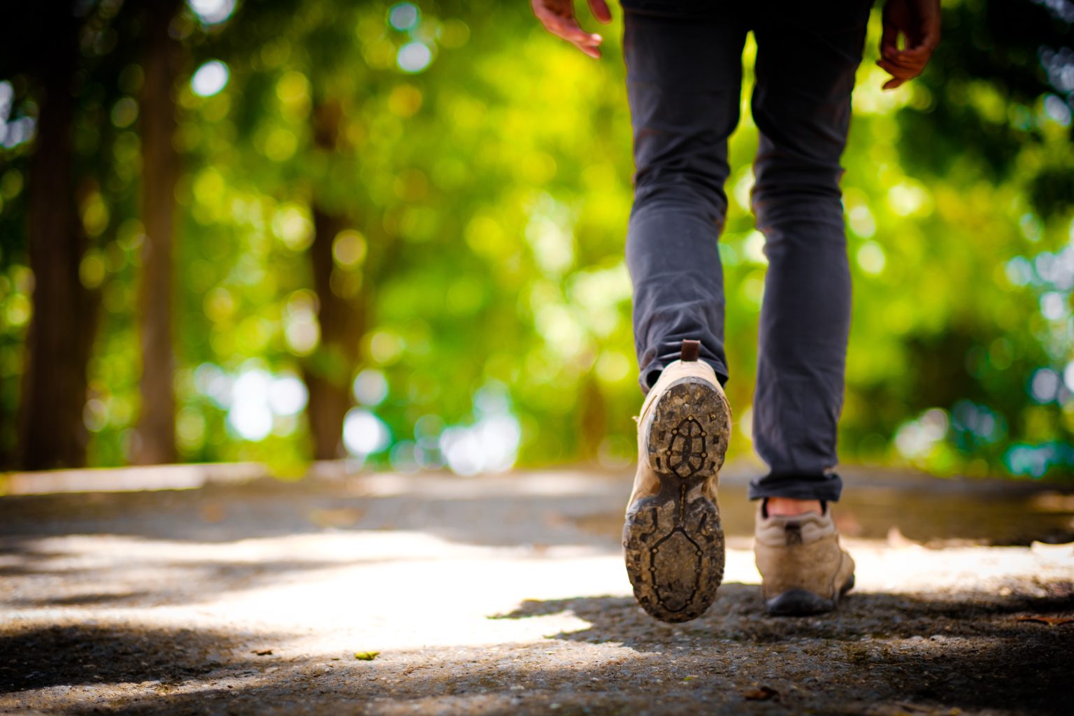 mans walking with walking boots on outside at national park