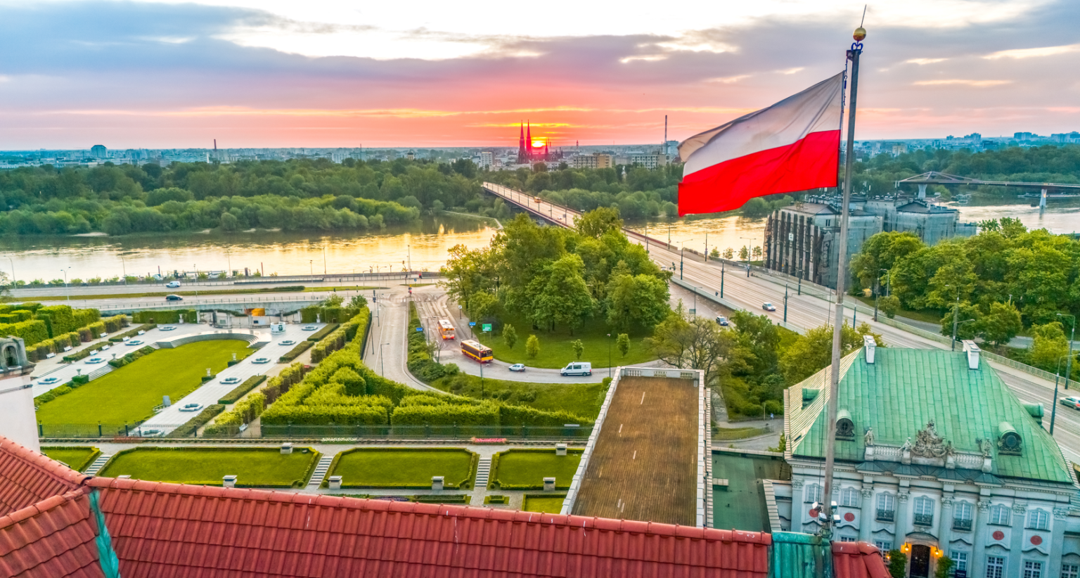 polish flag flying above castle square in Warsaw